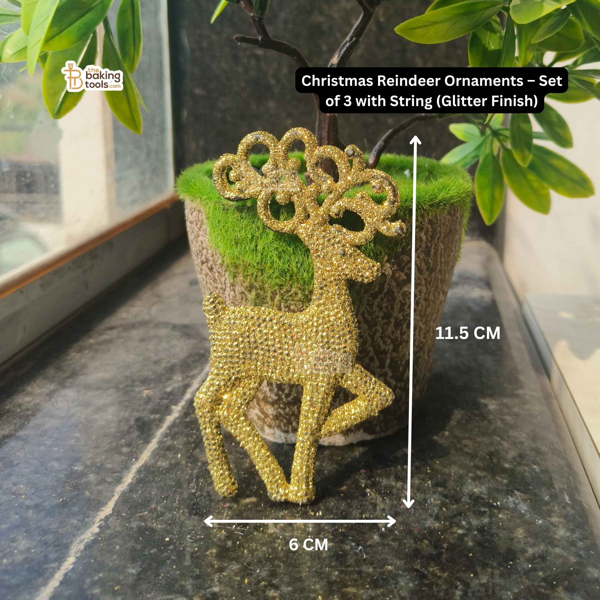 Gold glitter reindeer ornament on a green plant pot with measurements indicated.